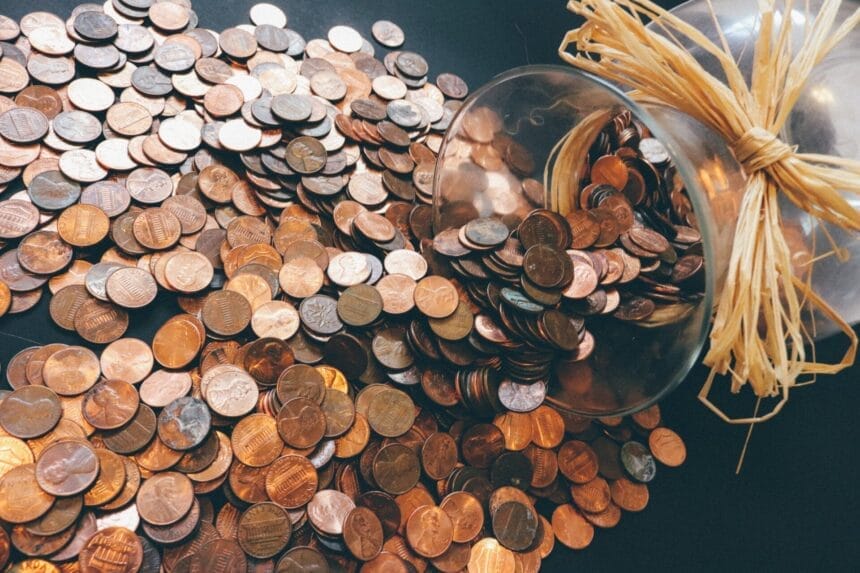 A glass jar filled with pennies.